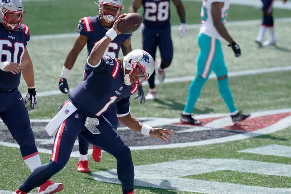 New England Patriots quarterback Cam Newton celebrates his rushing touchdown against the Miami Dolphins