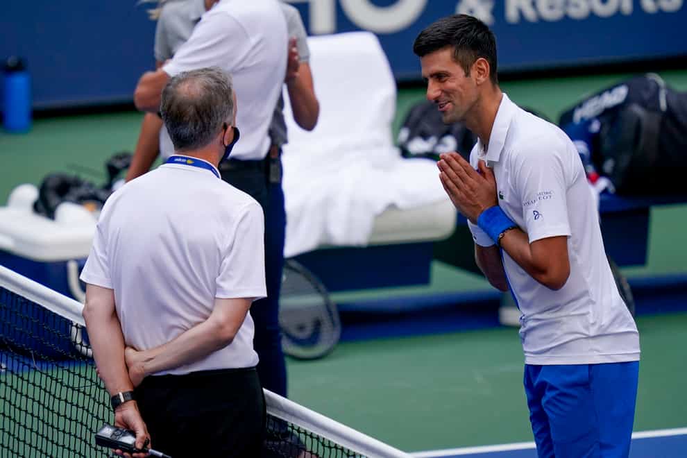 Novak Djokovic, right, was thrown out of the US Open after accidentally hitting a line judge with a ball