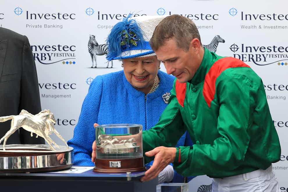 Pat Smullen is presented with his trophy for winning the Derby by the Queen