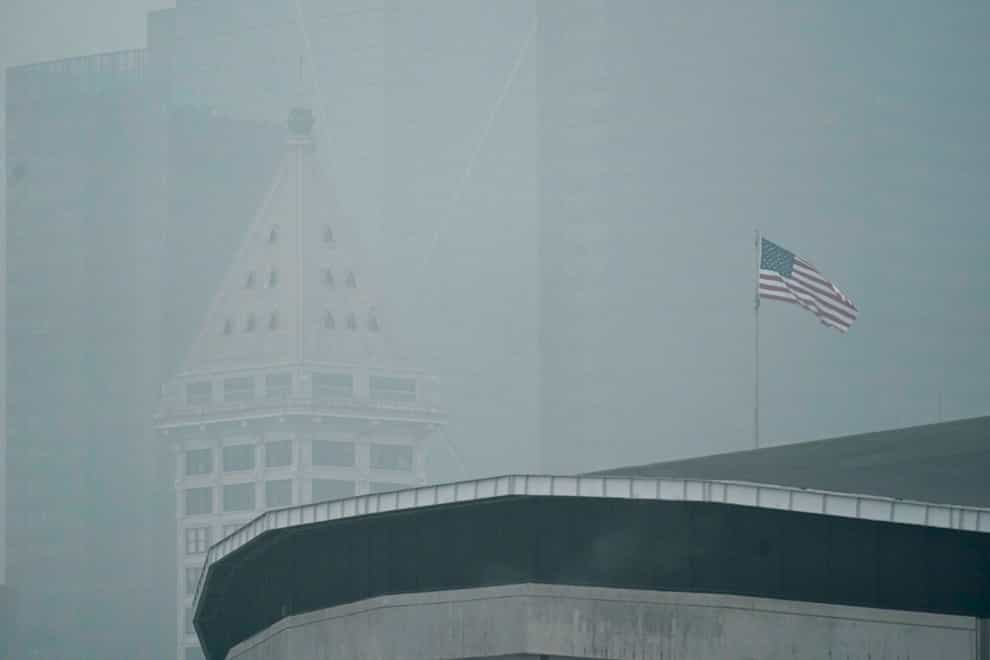 A US flag flies near Smith Tower in Seattle in air thick with smoke from wildfires