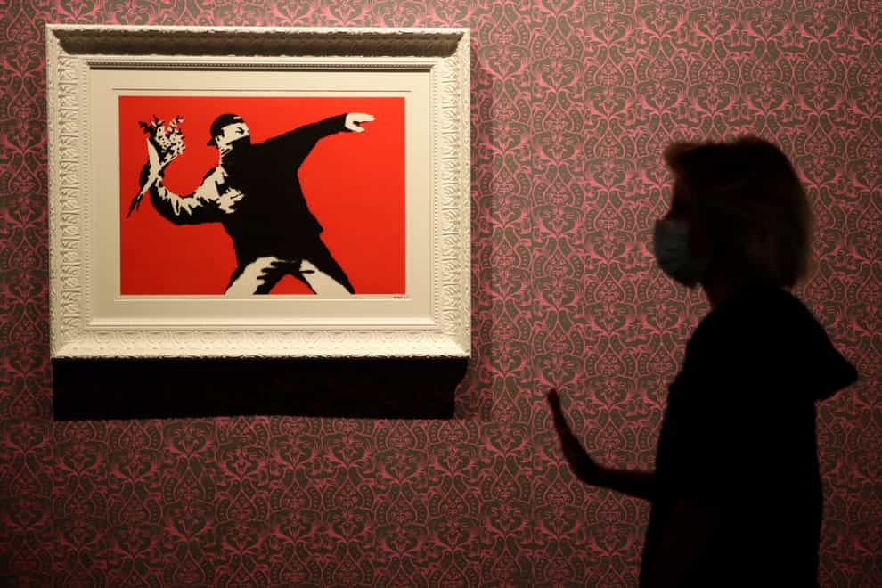 Banksy's Flower Thrower hangs in a gallery