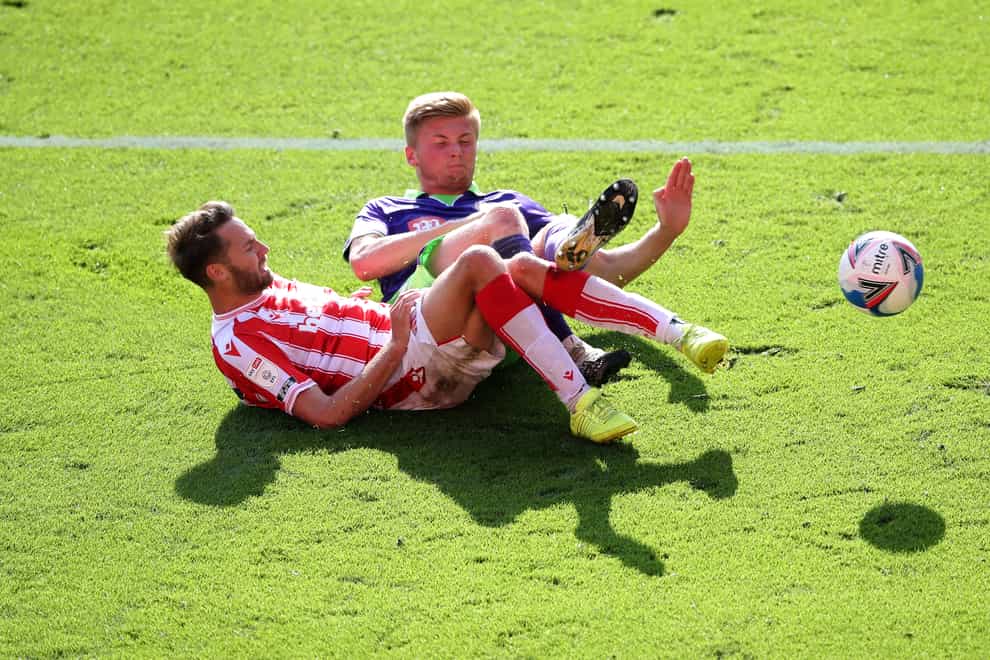 Bristol City's Taylor Moore, right, challenges Stoke's Nick Powell