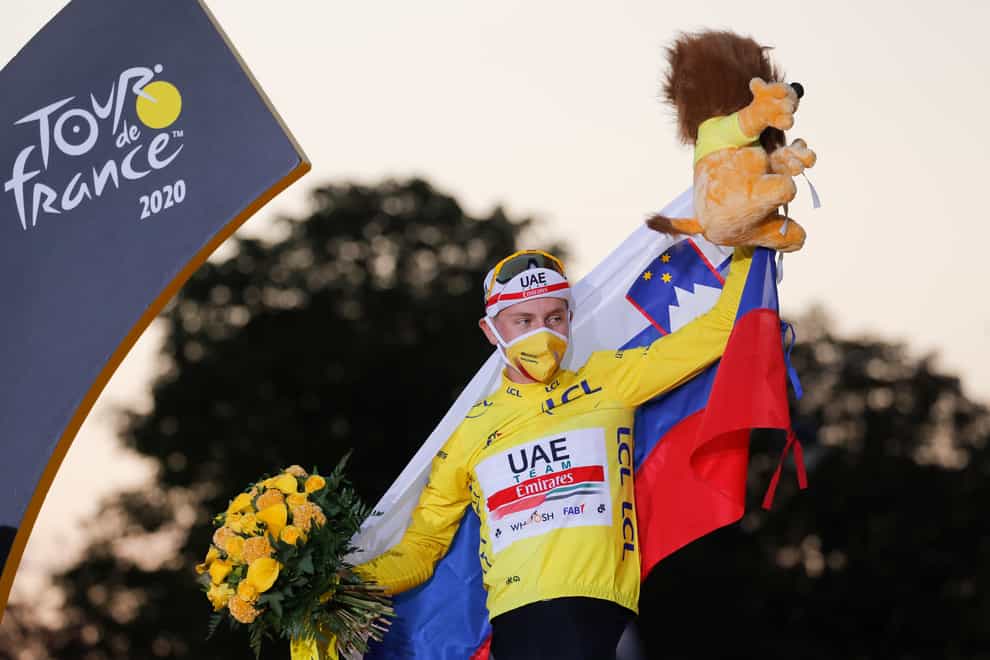 Tadej Pogacar celebrates his Tour de France victory on the podium in Paris