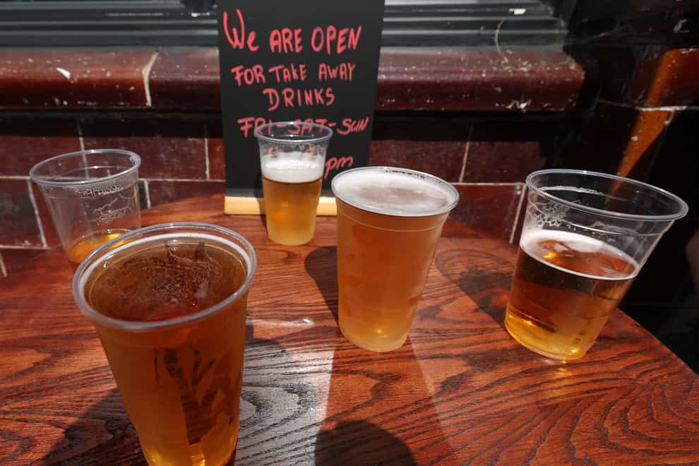 Takeaway pints of beer outside Charrington’s Noted Ales And Stout pub in London (Yui Mok/PA)