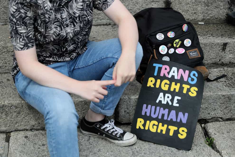 A person with a trans rights sign