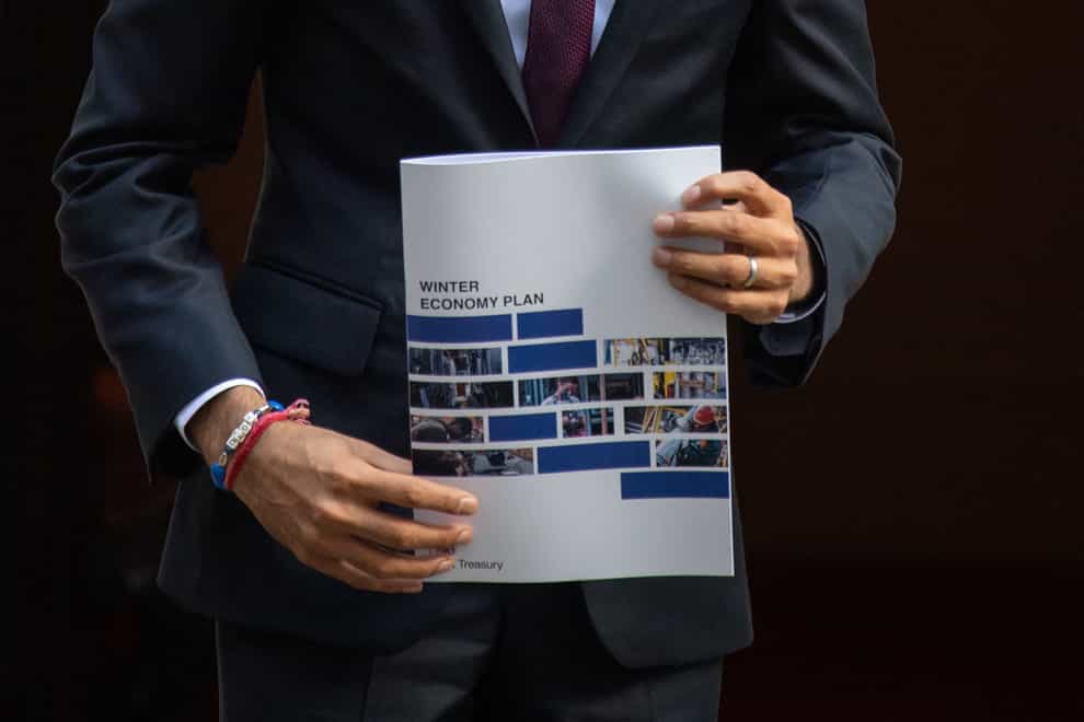 Rishi Sunak holds a copy of his Winter Economy Plan outside No 11 Downing Street
