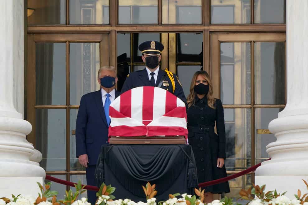 President Donald Trump and first lady Melania Trump pay respects