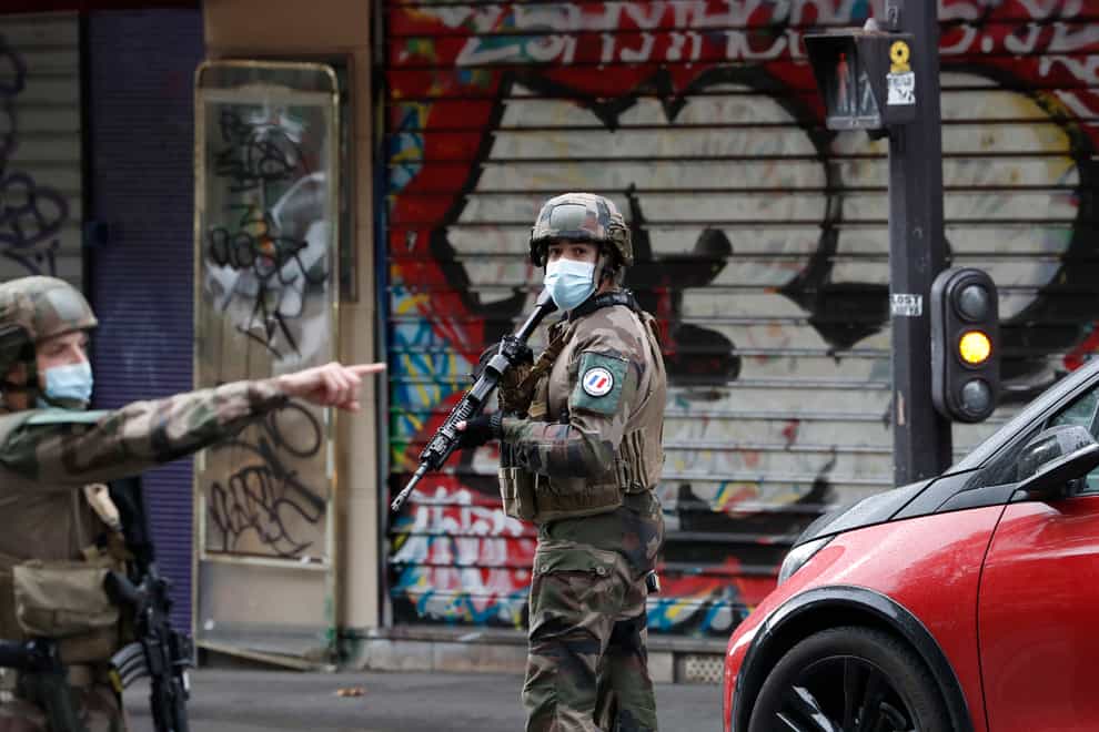 French soldiers on patrol after four people were wounded in a knife attack near the former offices of satirical newspaper Charlie Hebdo in Paris 