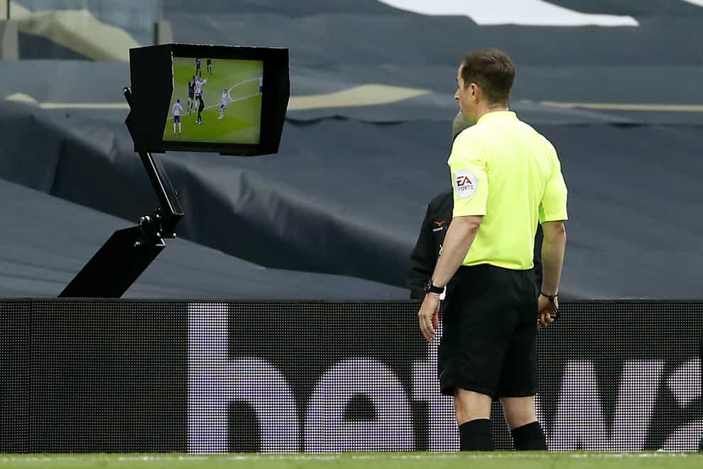 Referee Peter Bankes watched the late incident at Tottenham back on a pitchside monitor (Andrew Boyers/PA).
