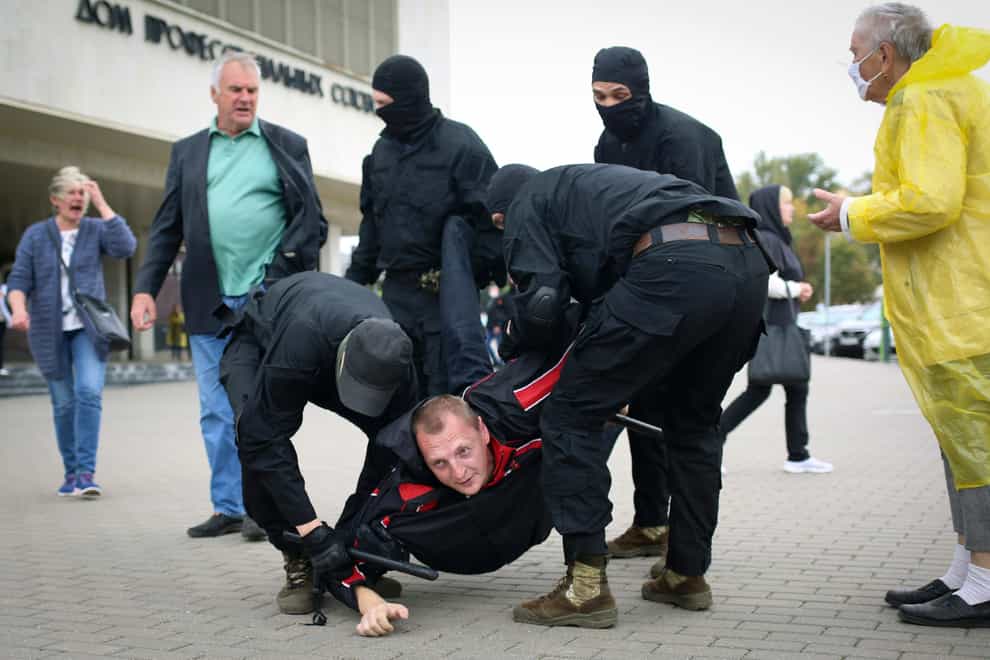 Police detain a man during an anti-government rally