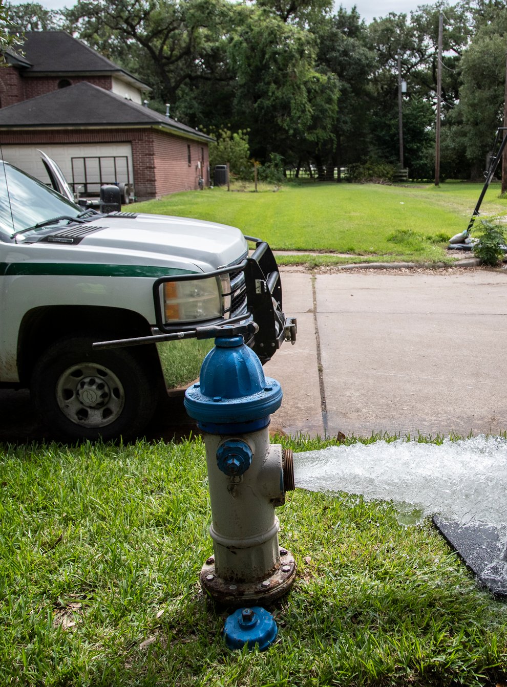 Kristina Watson, a Lake Jackson water waste operator, flushes water out from a fire hydrant
