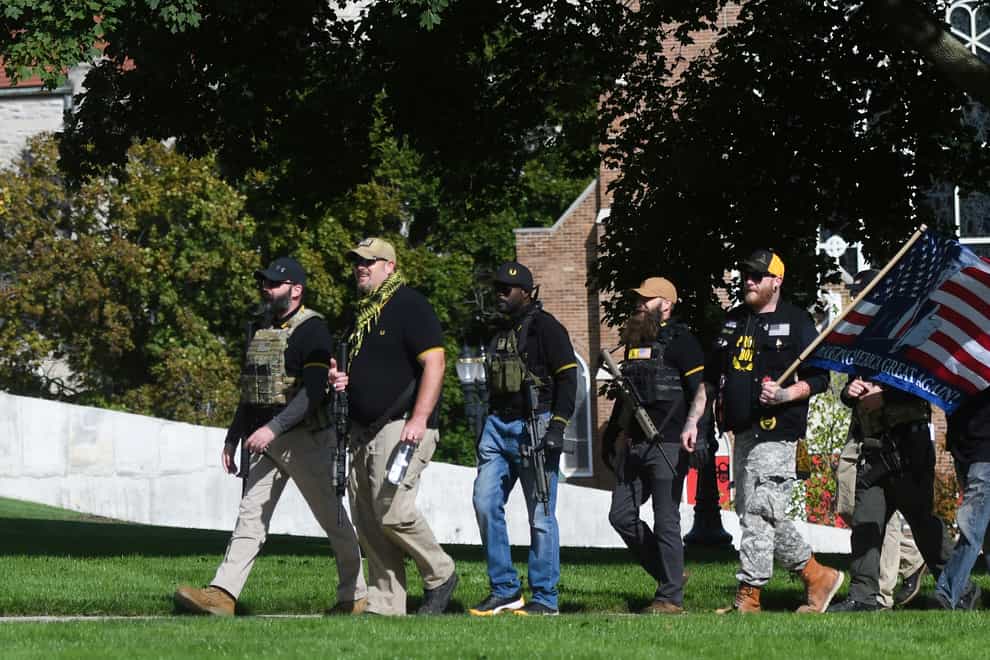 Members of the Proud Boys, some wearing the Fred Perry shirt, head towards the State Capitol building in Lansing, Michigan, earlier this month during a march