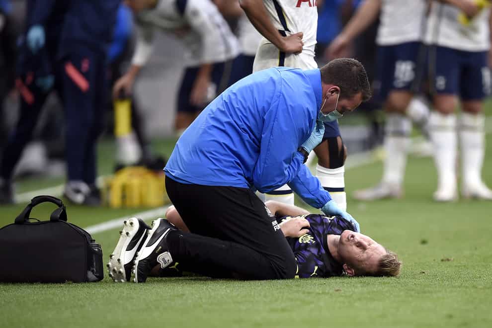 Newcastle's Matt Ritchie receives treatment on the pitch at Tottenham