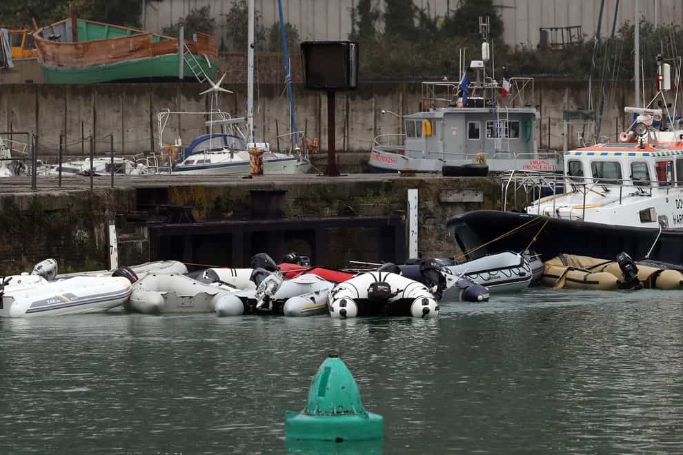 Small boats used in recent migrant crossings from the French coast are manoeuvred around Dover Marina by Dover Harbour Patrol before being placed into storage (Gareth Fuller/PA)