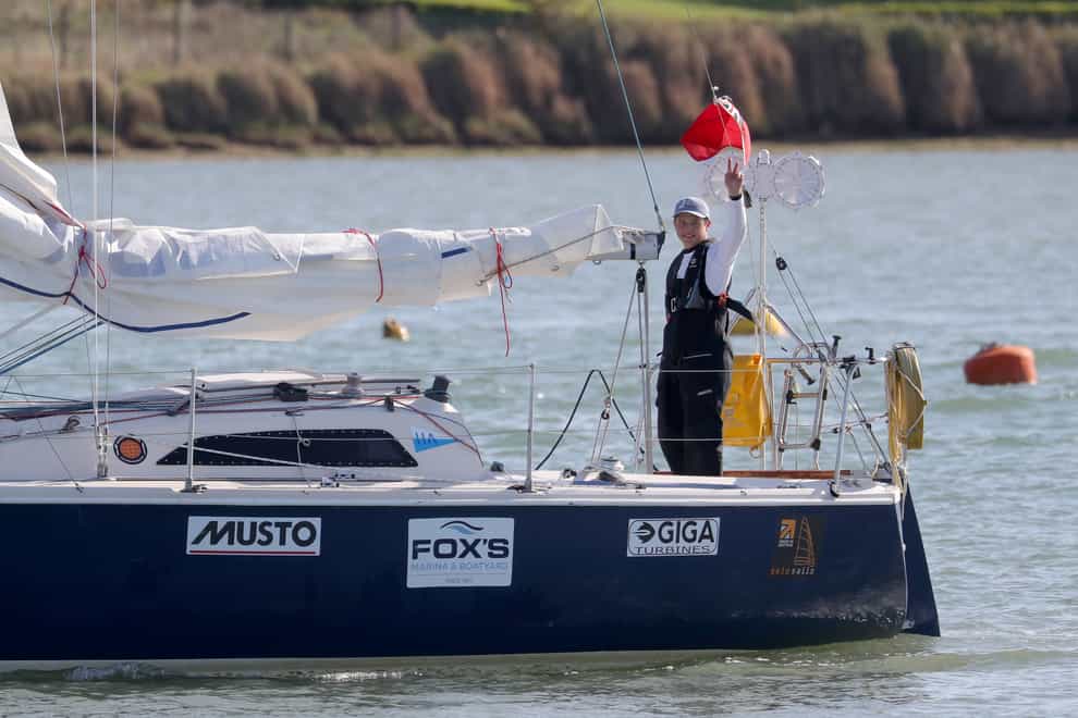 Timothy Long waves as he sails his 28ft boat into Hampshire