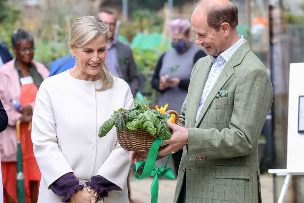 The Earl and Countess of Wessex with a gift during a visit to Vauxhall City Farm in London, to see the farm’s community engagement and education programmes in action, as the farm marks the start of Black History Month. Chris Jackson/PA Wire