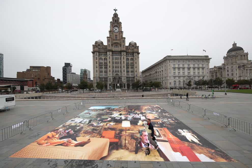 Artist Cold War Steve with his new piece of art, Trumpscape, outside the Liver Building in Liverpool (Danny Lawson/PA)