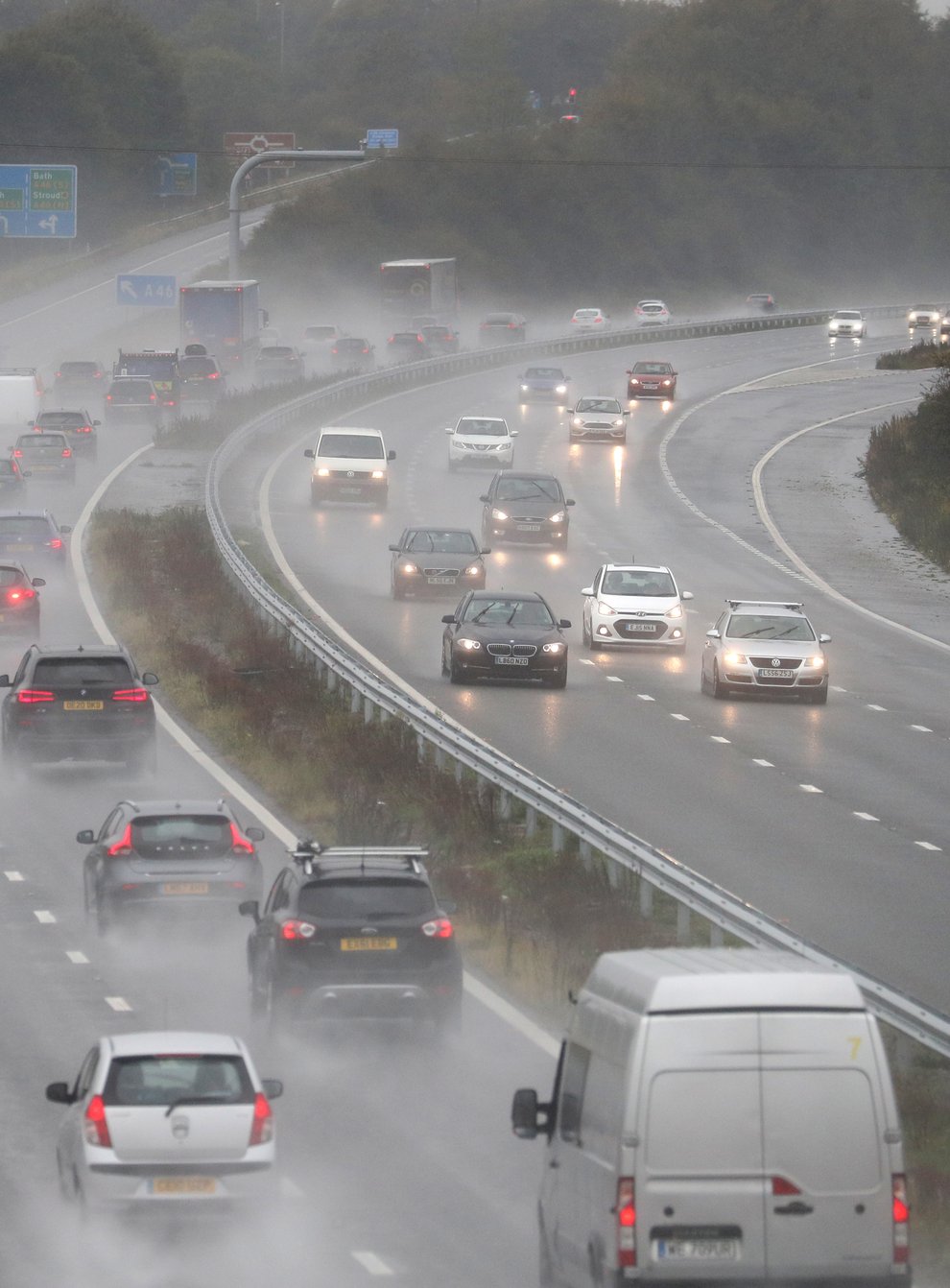 Cars make their way along the M4 motorway as heavy rain lashes the UK