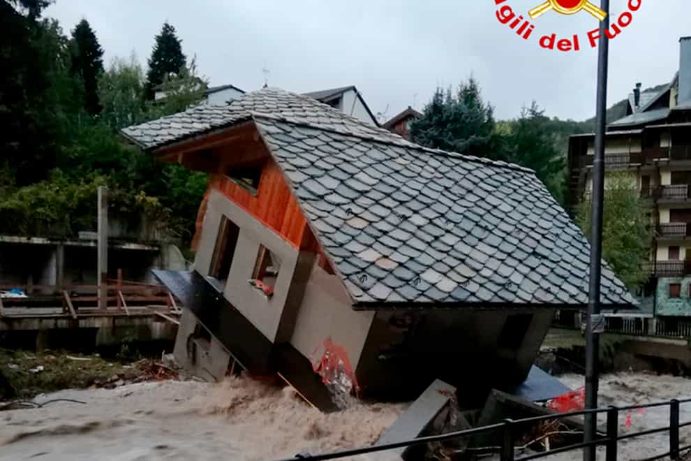 A building topples over by the Cervo river after heavy rains in Biella, northern Italy