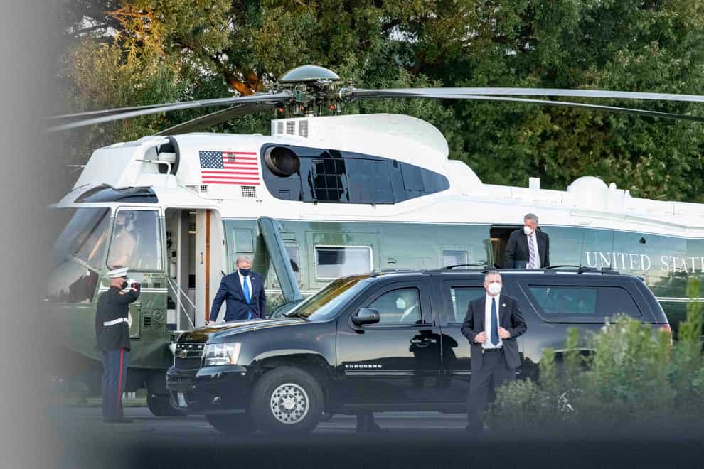 President Donald Trump arrives at Walter Reed Medical Center on Marine One for treatment after testing positive for Covid-19