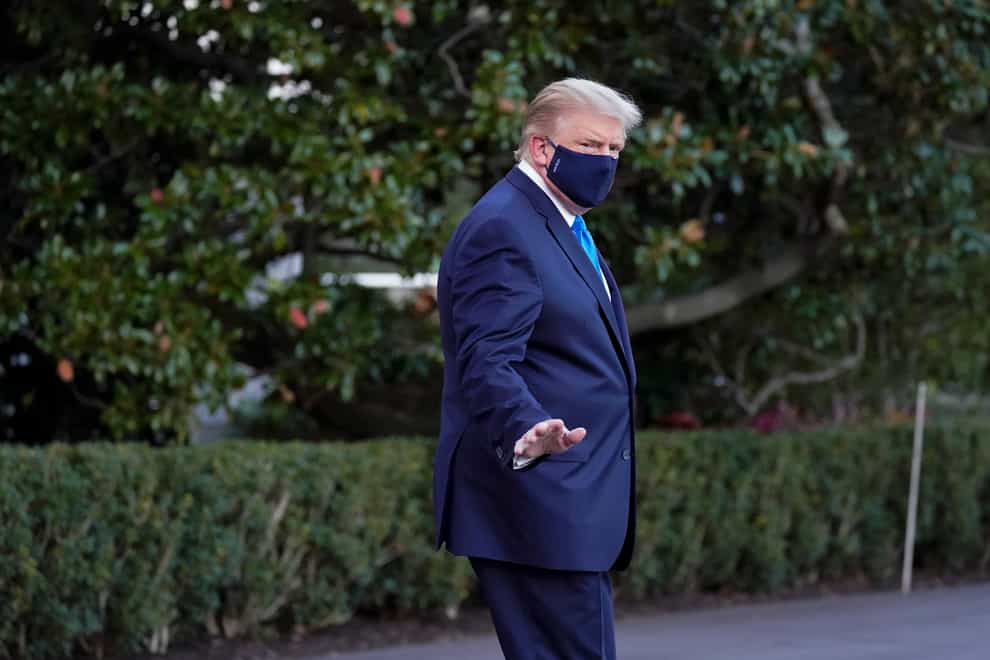 President Donald Trump waves to members of the media as he leaves the White House to go to Walter Reed National Military Medical Centre