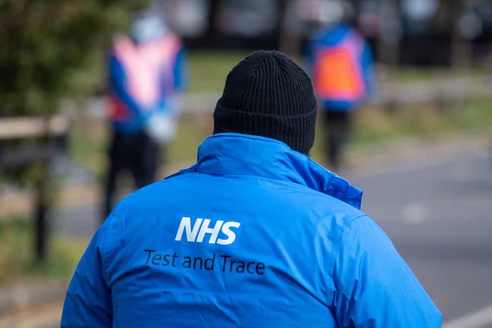 An NHS Test and Trace logo on a member of staff’s jacket (Dominic Lipinski/PA)