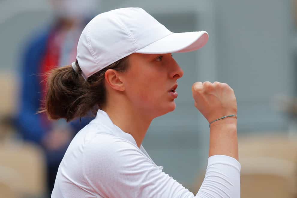 Iga Swiatek clenches her fist during her semi-final victory over Nadia Podoroska