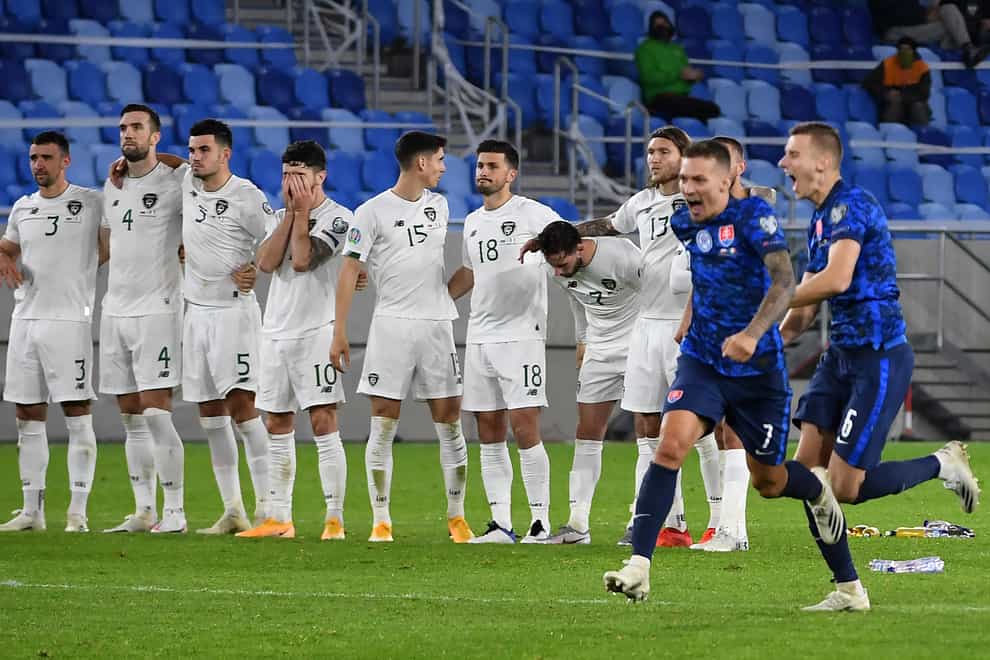 Republic of Ireland players look on as Slovakia celebrate their penalty shoot-out victory