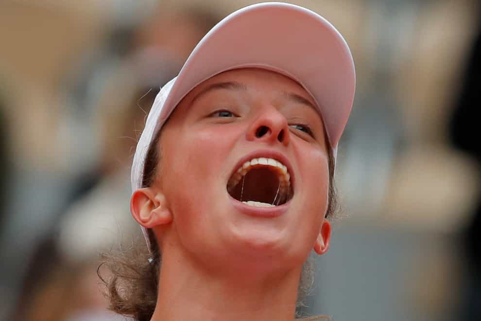 Iga Swiatek screams in delight after winning the French Open title