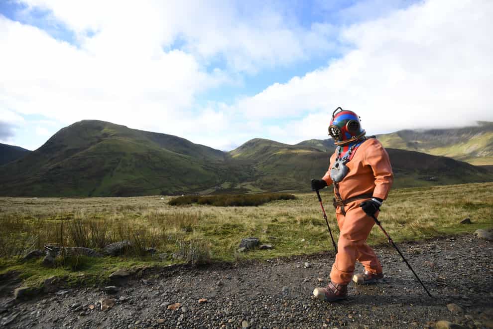 Veteran fundraiser Lloyd Scott, who is attempting to climb the Three Peaks in aid of Lord's Taverners charity whilst wearing a deep sea diving suit during his challenge on the final peak, Mount Snowdon in Snowdonia, north Wales.