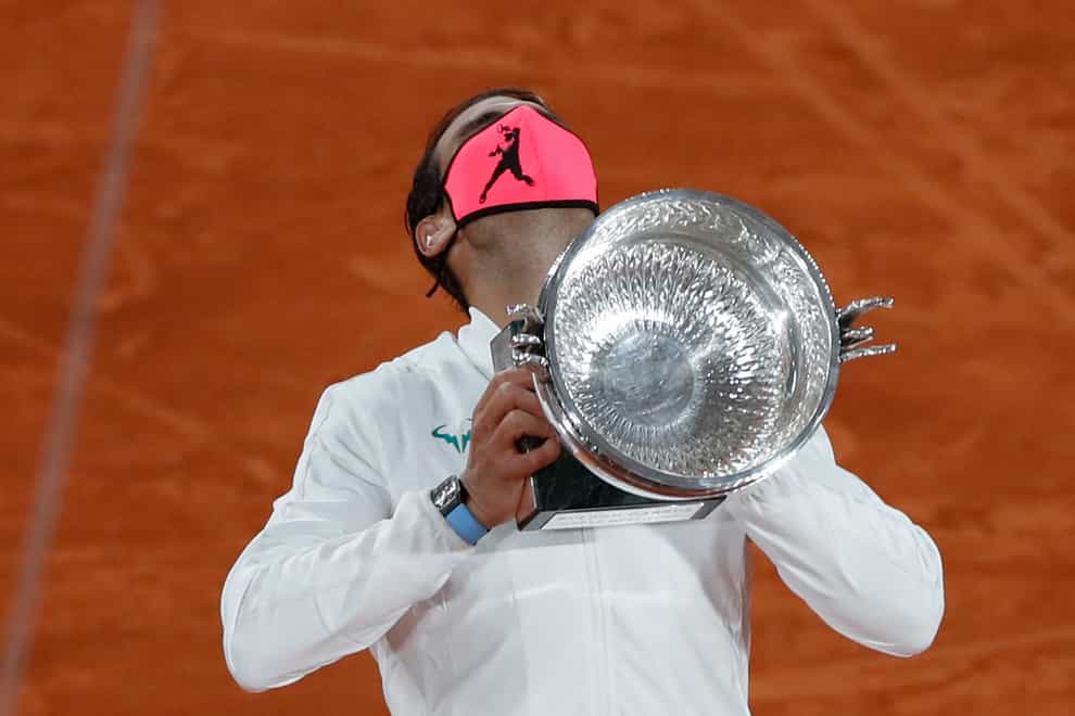 Rafael Nadal lifted his 13th French Open trophy after a straight-sets win over Novak Djokovic