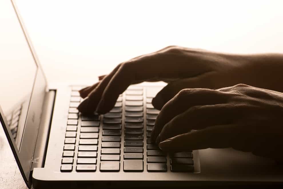 A woman’s hands on a laptop keyboard
