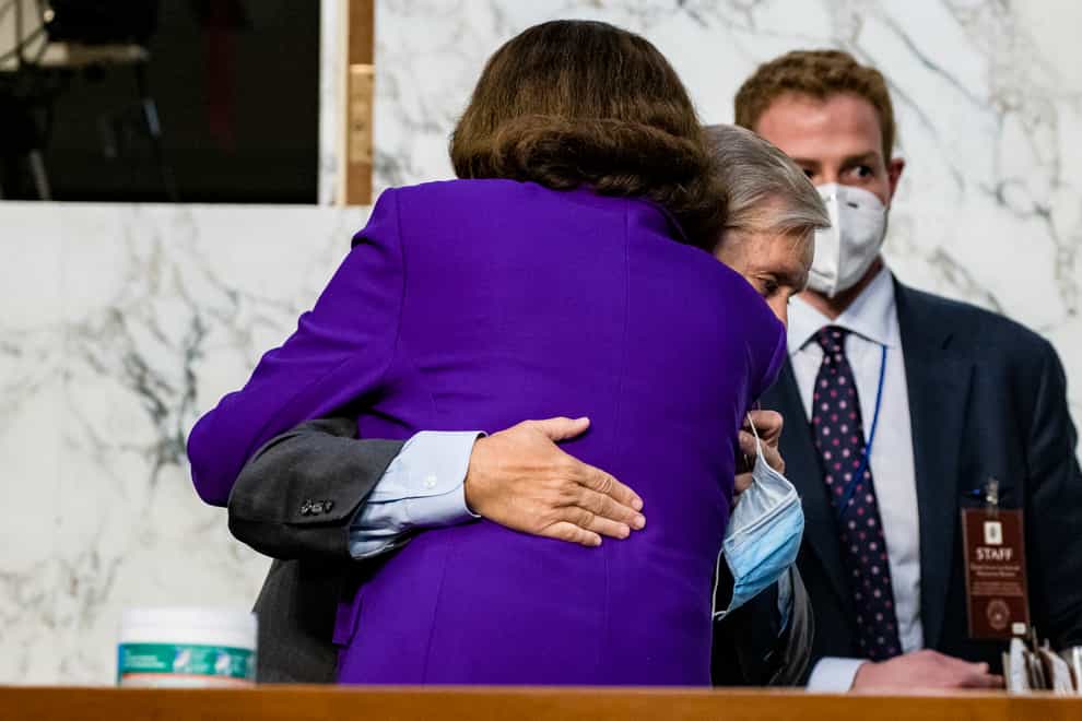 Senator Lindsey Graham hugs Senator Dianne Feinstein at the close of the confirmation hearing for Supreme Court nominee Amy Coney Barrett (Samuel Corum/AP)