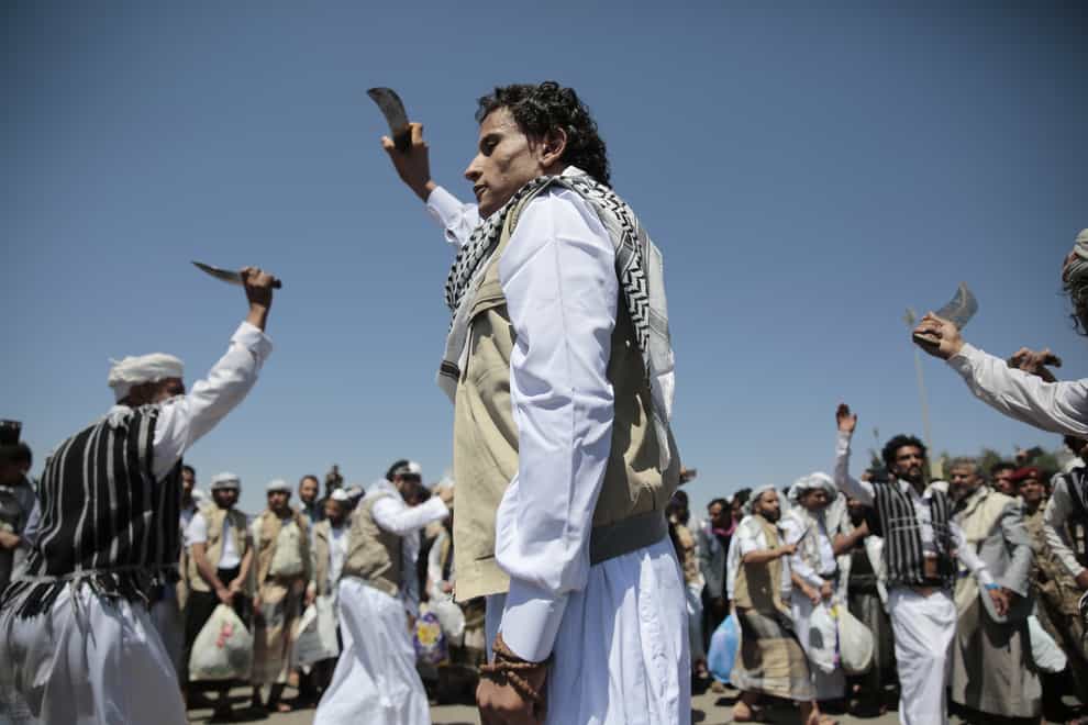 A Yemeni prisoner, centre, performs a traditional dance during his arrival after being released by the Saudi-led coalition (Hani Mohammed/AP)