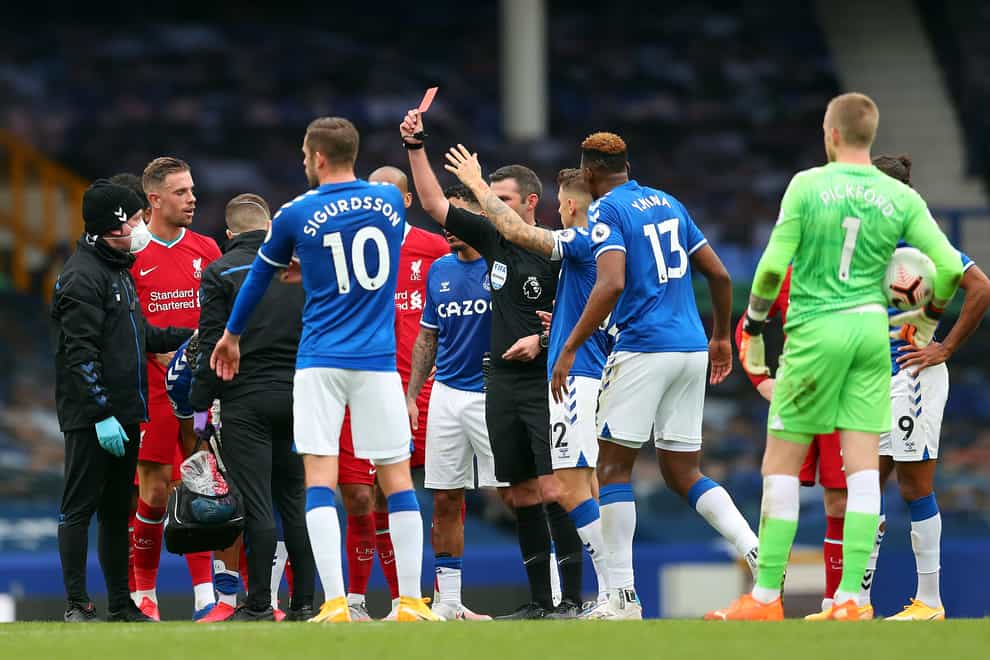 Richarlison, obscured, is shown a red card during the closing stages