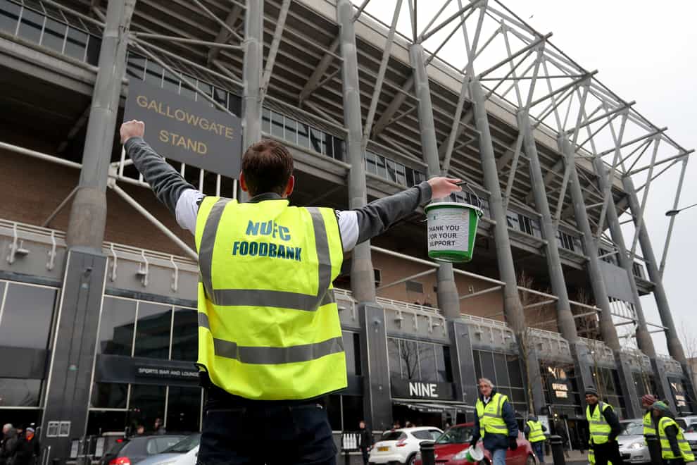 A man collects for the NUFC Food Bank before the Premier League match against Cardiff in January 2019