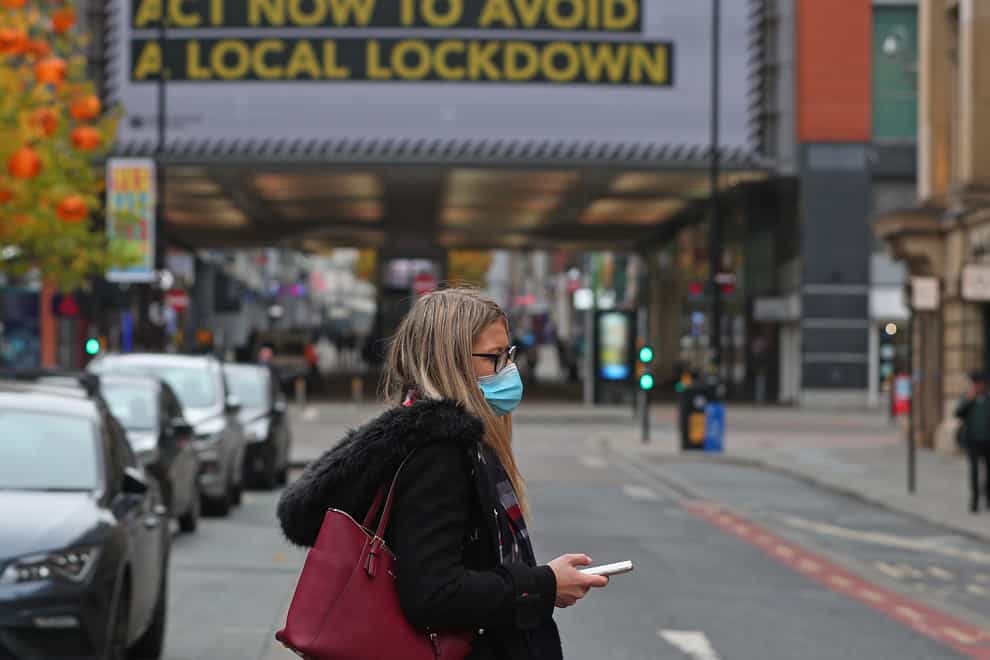 A woman wearing a face mask in Manchester city centre (Peter Byrne/PA)
