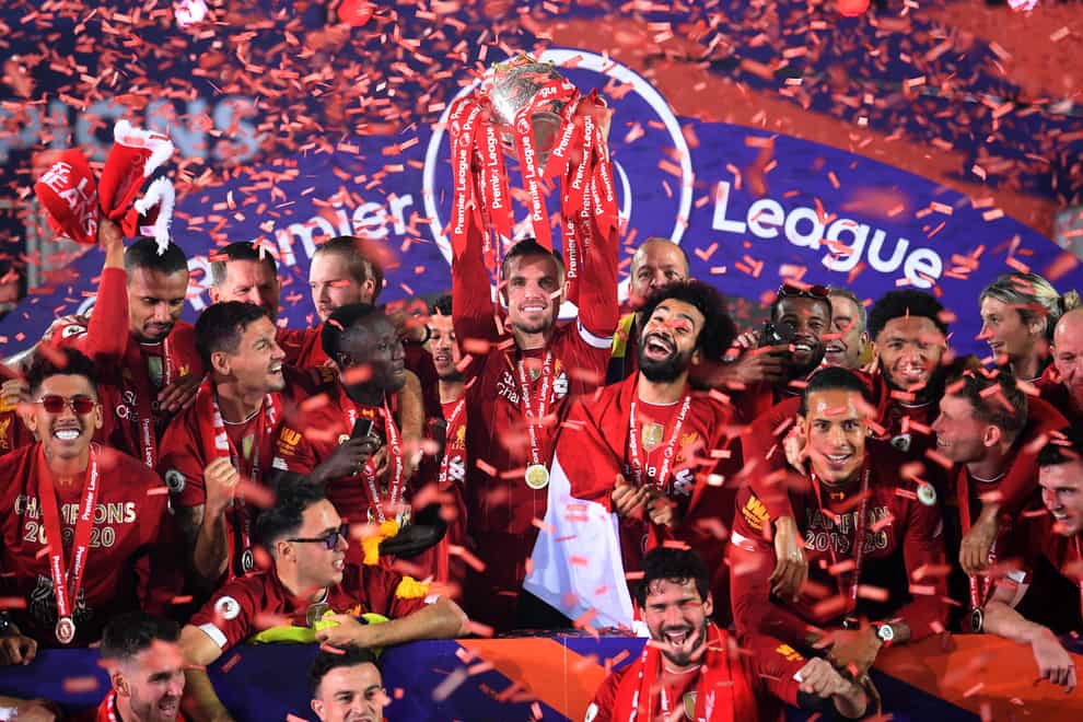 Liverpool captain Jordan Henderson (centre) lifts the Premier League trophy
