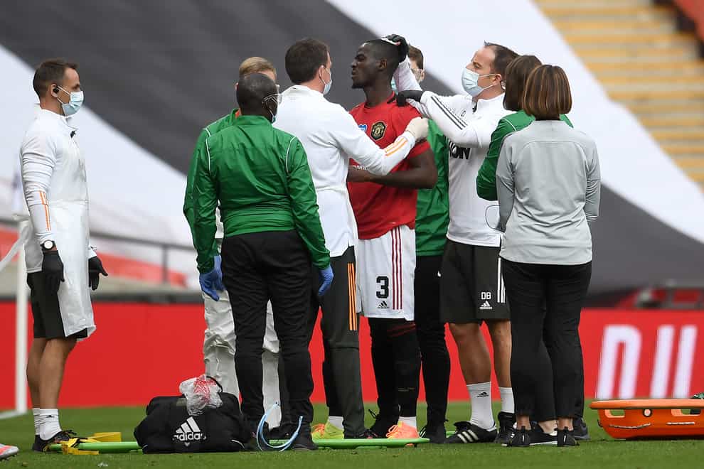 Manchester United's Eric Bailly receives treatment for a head injury