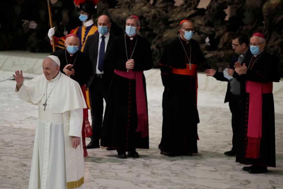 Pope Francis waves to faithful at the end of the weekly general audience in the Paul VI hall at the Vatican
