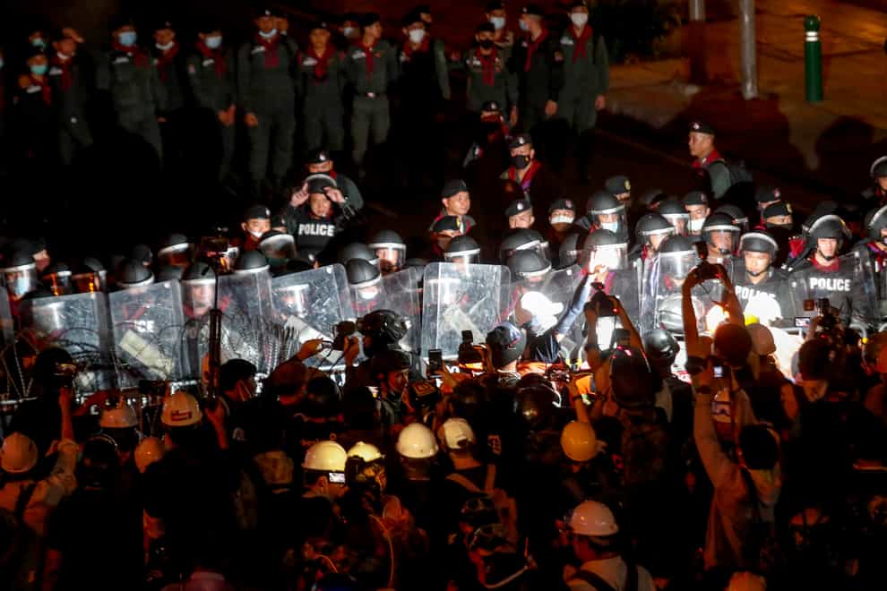 Pro-democracy activists confront a police blockage