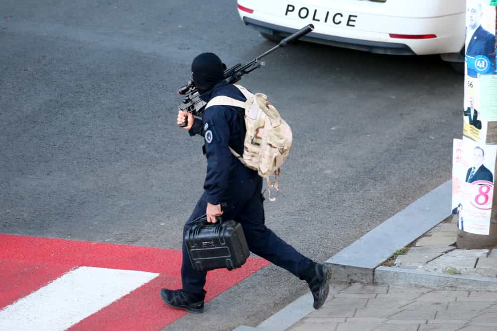 A Georgian police sniper carries his rifle