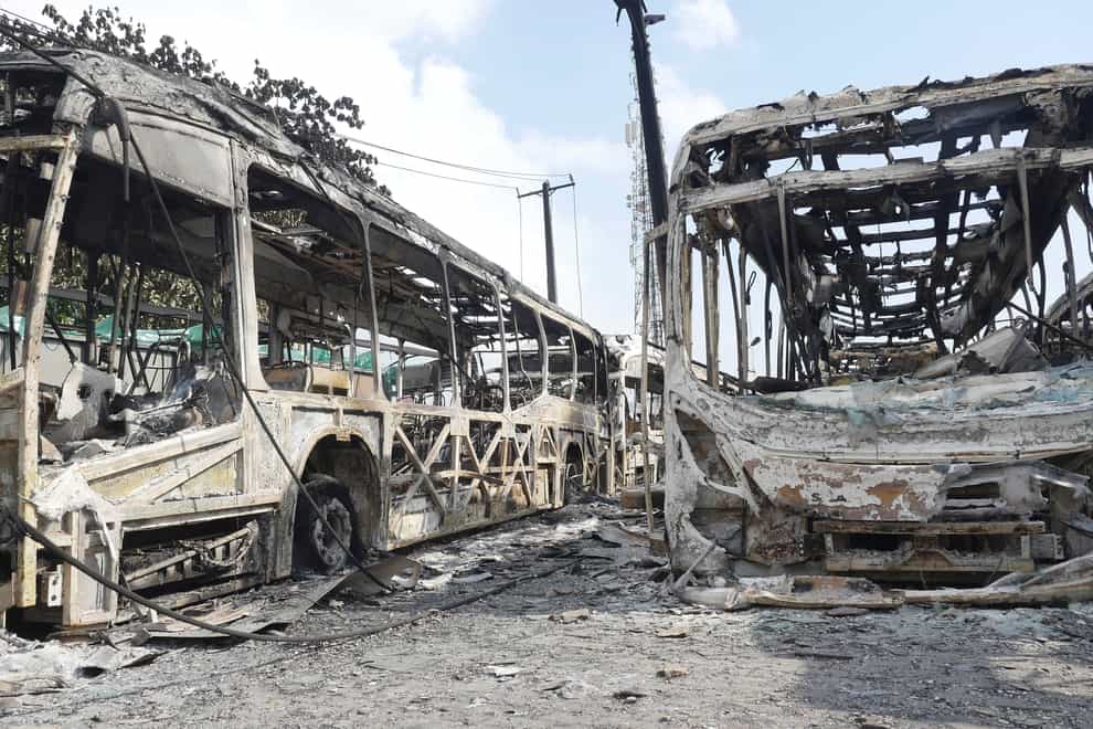Burnt out government buses at the Berger station near Ikeja, Lagos (AP)