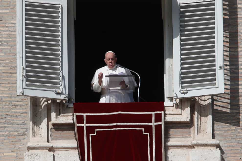 Pope Francis delivers his message during the Angelus noon prayer from the window of his studio overlooking St Peter’s Square