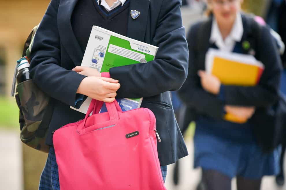Pupils carry bags and books
