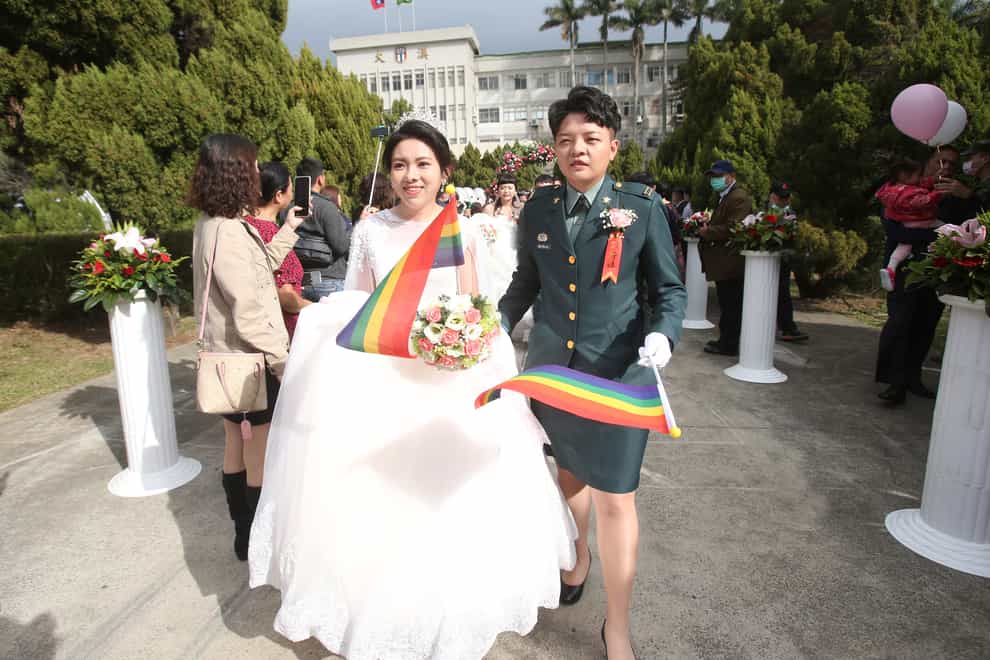 Lesbian couple Chen Ying-hsuan, right, and Li Li-chen attend a military mass weddings ceremony in Taoyuan city, northern Taiwan (Chiang Ying-ying/AP)