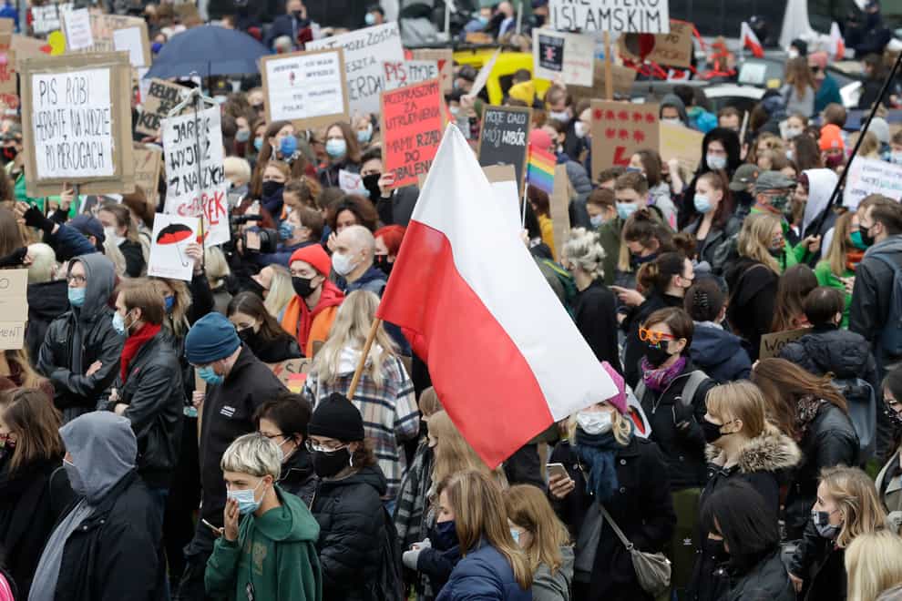 Women’s rights activists hold placards during a protest in Warsaw, Poland (Czarek Sokolowski/AP)