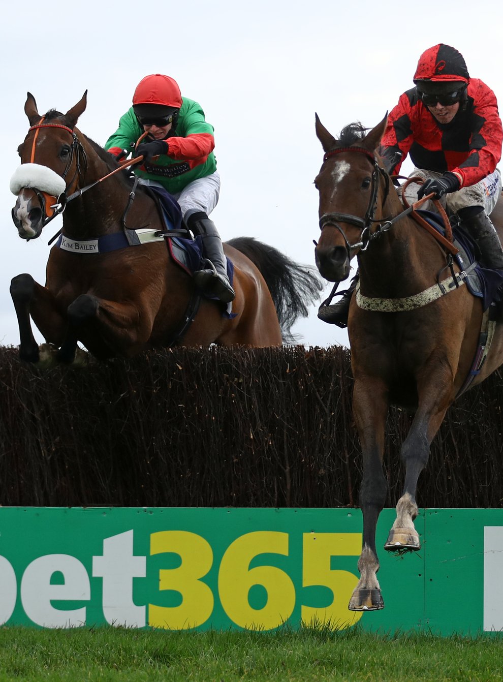 Huntsman Son (right) and Kielan Woods jump the last fence on their way to winning the Cash Out At bet365 Handicap Chase at Wetherby