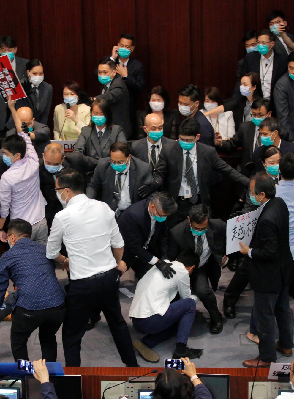 Pro-establishment politician, Starry Lee, centre, speaks as pan-democratic legislators scuffle with security guards and pro-China legislators in Hong Kong, Friday, May 8, 2020