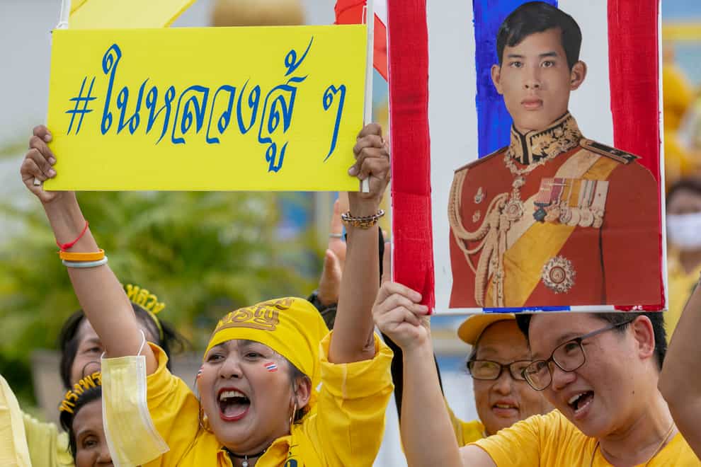 Supporters of the monarchy display images of King Maha Vajiralongkorn as they gather in front of the Grand Place in Bangkok, Thailand, Sunday (Wason Wanichakom/AP)